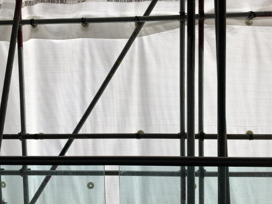 view from a high rise flat when the window is covered by scaffolding and white plastic sheeting